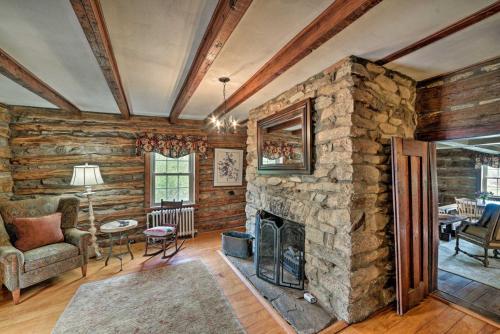 a living room with a stone fireplace in a house at Events and Concierge, 6BR Heated Pool Near Wineries in Hume
