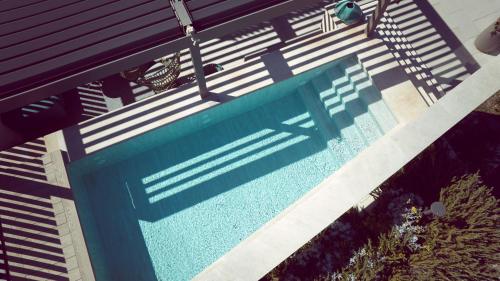 a swimming pool with a blue bench in a yard at El Vicenç de la Mar - Adults Only - Over 12 in Pollença