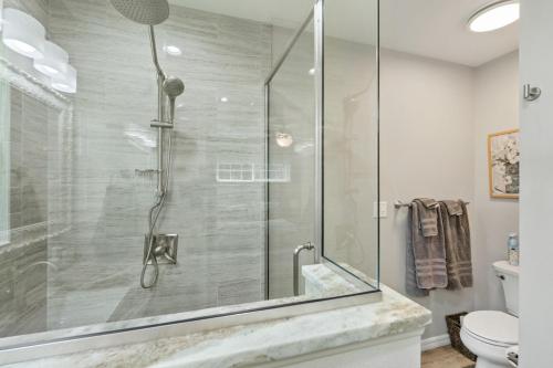 a shower with a glass door in a bathroom at Dunnellon Dream. Pool, Fire Pit and Outdoor Bar in Dunnellon