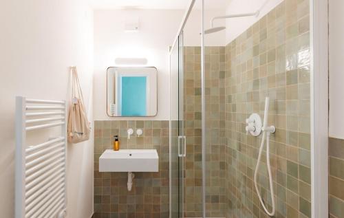 a bathroom with a sink and a shower at Tomato Urban Retreat in Turin
