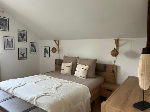 une chambre avec un lit et une table en bois dans l'établissement La Maison Zanzibar, à Lavilletertre