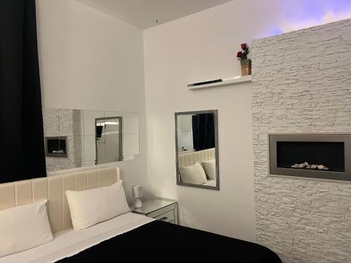a bedroom with a bed and a fireplace at Palese Profumo di Mare in Santo Spirito