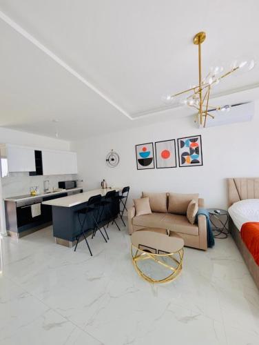 a white living room with a couch and a table at Modern Luxury Apartment in Aglantzia