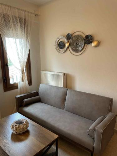 a living room with a couch and a table at Niki's Paradise View in Taxiarchis