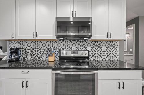 a kitchen with a stove and a microwave at Central Huge Duplex - Sleeps 16 in Wheat Ridge