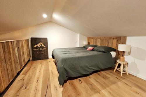 a bedroom with a large bed in a attic at Le Loft de Genas - la Bastide, le Chalet, le Loft, le Mas, la Paillote in Genas