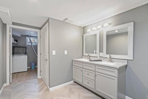a bathroom with a sink and a mirror at Central Huge Duplex - Sleeps 16 in Wheat Ridge