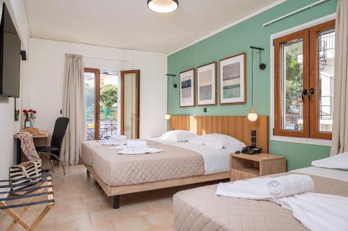 A bed or beds in a room at Emily Hotel