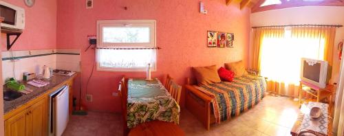 a small room with a bed and a window at Secretos del quebracho in Capilla del Monte