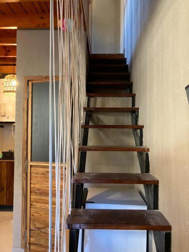 a wooden staircase in a house with ropes at Modern apartment in San Fernando in San Fernando