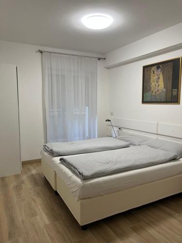 a bedroom with two beds and a window at Villa Dina in Riva del Garda