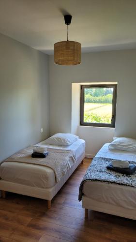deux lits dans une chambre avec une fenêtre dans l'établissement Villa paisible en Provence, à Orange