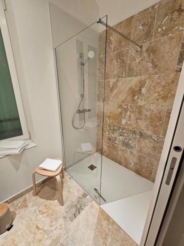 a shower with a glass door in a bathroom at Le Loft de Genas - la Bastide, le Chalet, le Loft, le Mas, la Paillote in Genas