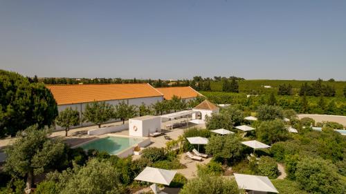 an aerial view of a resort with a pool and umbrellas at Casas da Quinta de Cima in Vila Nova De Cacela