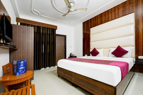 a bedroom with a large bed and a television at Hotel Stay Villa - Free Airport Drop in New Delhi