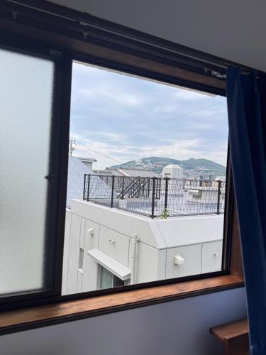 a window with a view of a building at お宿花水木 in Nagasaki