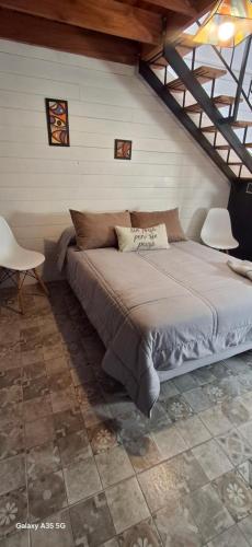 a bedroom with a large bed in a attic at Ana home's in Mar del Plata