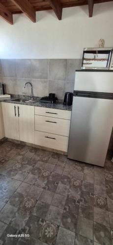a kitchen with a sink and a refrigerator at Ana home's in Mar del Plata