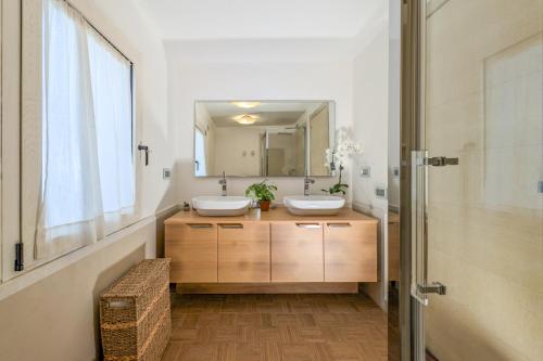 a bathroom with two sinks and a mirror at Villa Bianca in Villasimius