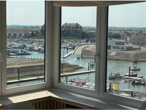 a view of a harbor from a window at Luxury 2-bedroom apartment with marina views in Blankenberge T205 in Blankenberge