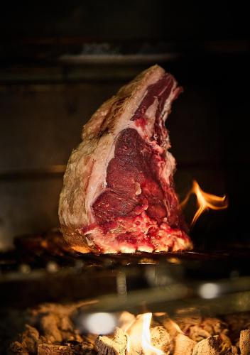 a large piece of meat cooking in an oven at 25hours Hotel Florence Piazza San Paolino in Florence