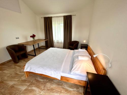 una camera da letto con un letto e un tavolo con sedie di Luxor a Havířov