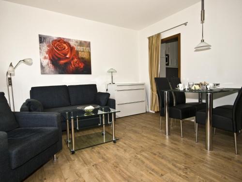 a living room with a couch and a table at Ferienwohnungen im Hotel Royal in Timmendorfer Strand