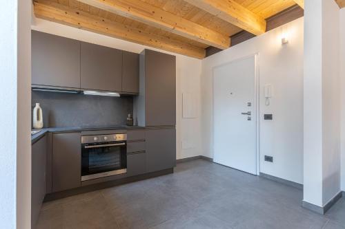 an empty kitchen with a stove and a door at GuestHost - Le Agavi Apartments in Ferrara