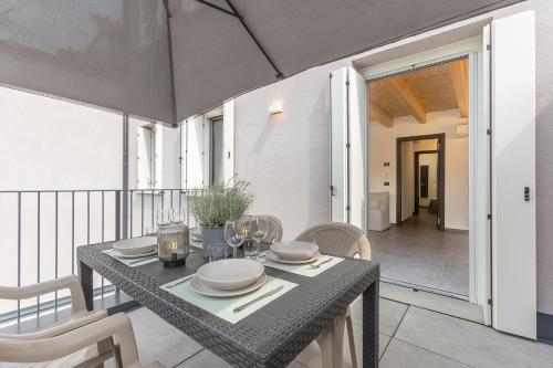 a dining table and chairs on a balcony at GuestHost - Le Agavi Apartments in Ferrara