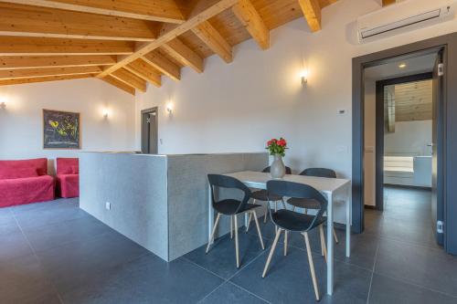 a kitchen and living room with a table and chairs at GuestHost - Le Agavi Apartments in Ferrara
