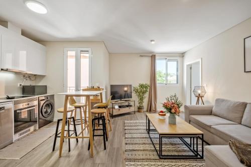 a living room with a couch and a table at Carmo Heritage Apartments in Funchal