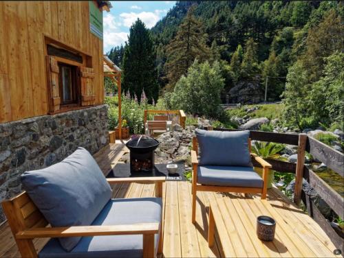 a patio with two chairs and a fire place at Gite de charme 3 étoiles in Belvédère