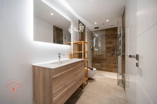 a bathroom with a sink and a shower and a toilet at Luxury Seaview Villa Celeste - TCM in Torrox