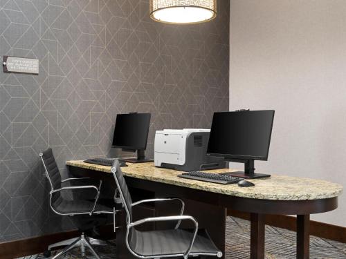 an office with two computer monitors on a desk at Homewood Suites by Hilton Akron/Fairlawn in Akron