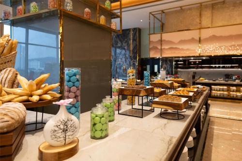 a bakery with a bunch of food on a counter at Radisson Blu Ha Long Bay in Ha Long