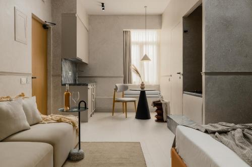 a living room with a couch and a table at Luxury Suites by Lato in Agios Nikolaos
