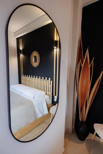 a mirror reflecting a bedroom with a bed in it at Historical View in Kalamata