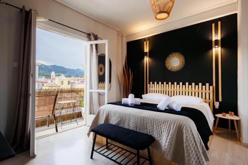 a bedroom with a large bed and a large window at Historical View in Kalamata