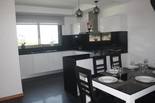 a kitchen with a table with chairs and a dining room at Calçada Velha in Viana do Castelo