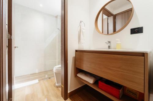 a bathroom with a sink and a mirror at Downtown Punta Cana Central Park E-300 in Punta Cana