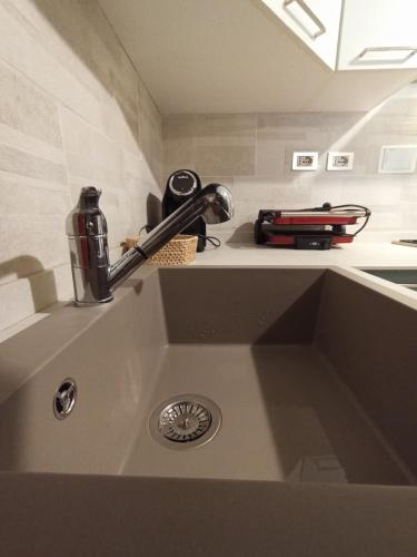 a kitchen sink with a faucet on top of it at Il nido Perugia in Perugia
