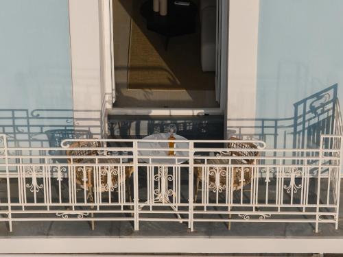 a group of dogs sitting in a white fence at Luxury Suites by Lato in Agios Nikolaos