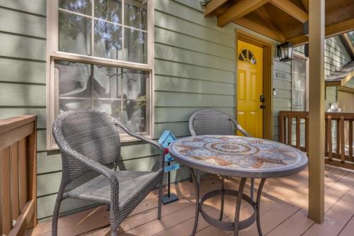 a patio with two chairs and a table on a porch at Lupine Chalet in Rhododendron