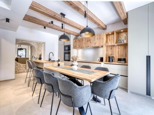 a kitchen with a wooden table and chairs at Holiday Home Domagoj by Interhome in Malinska