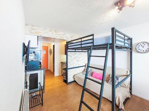 une chambre avec deux lits superposés et une télévision dans l'établissement Studio Pegase Phenix-66 by Interhome, au Corbier