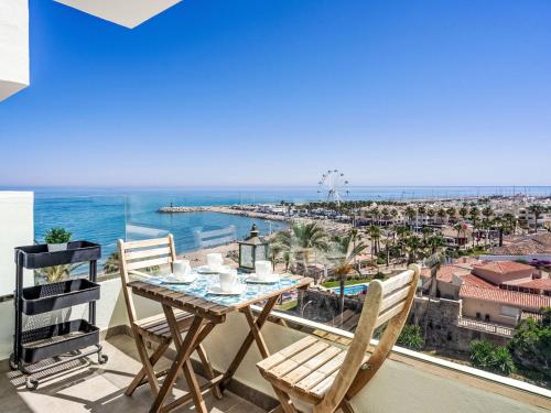 a table and chairs on a balcony with a view of the ocean at Apartment O-House by Interhome in Torremolinos