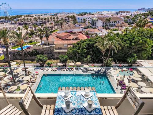 a view of the pool and beach from the balcony of a resort at Apartment O-House by Interhome in Torremolinos