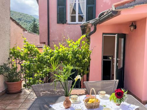 a table with a basket of fruit on a patio at Apartment Le Volte by Interhome in Pantasina