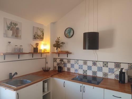 a kitchen with a sink and a counter top at Ático Vista La Sierra in Jarandilla de la Vera