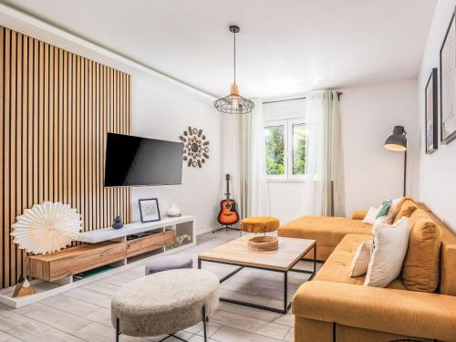 a living room with a couch and a tv at Holiday Home Manea by Interhome in Tribalj